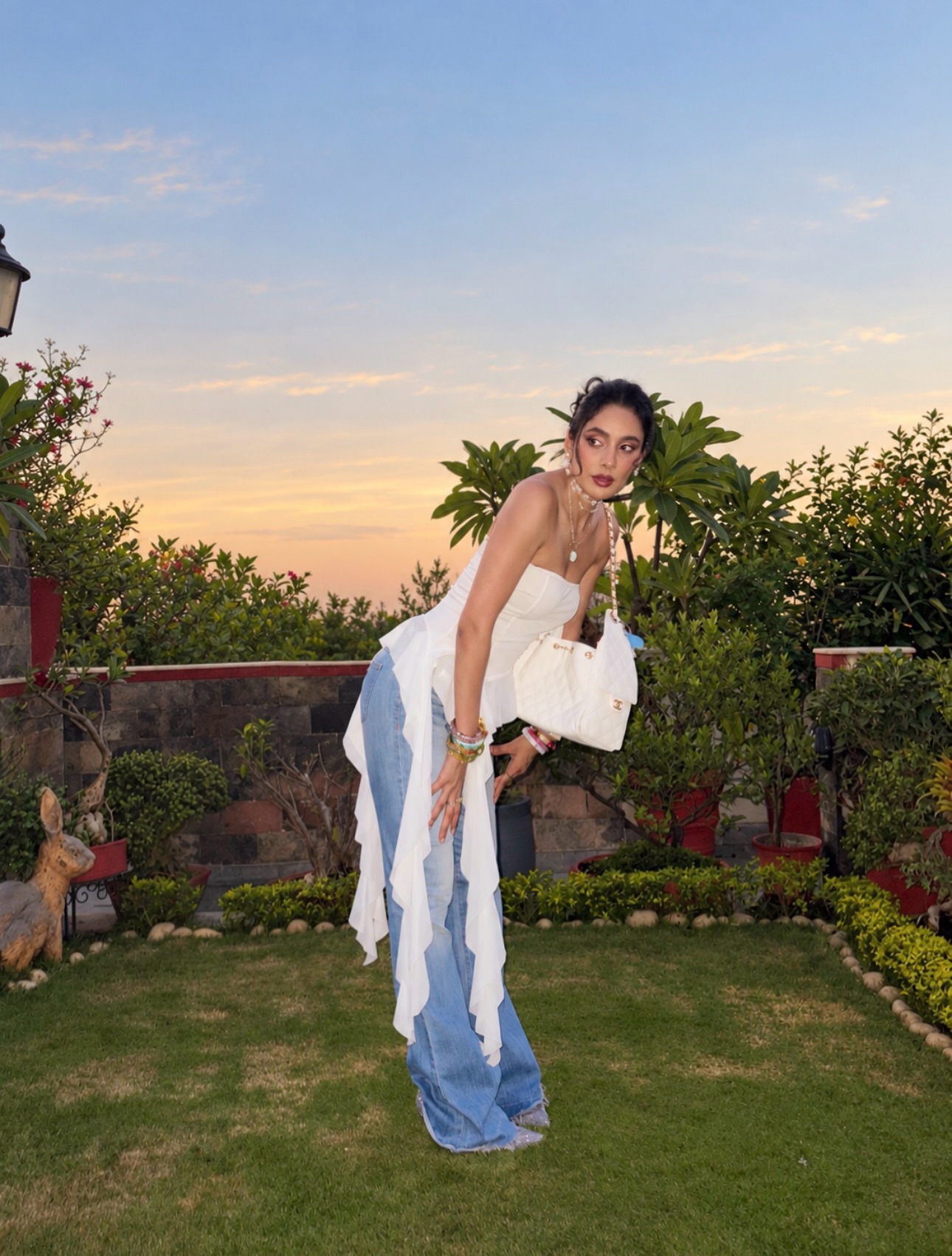Ishita Mangal turns heads in a structured white corset-style top featuring flowing draped details that add movement and drama to the contemporary look.