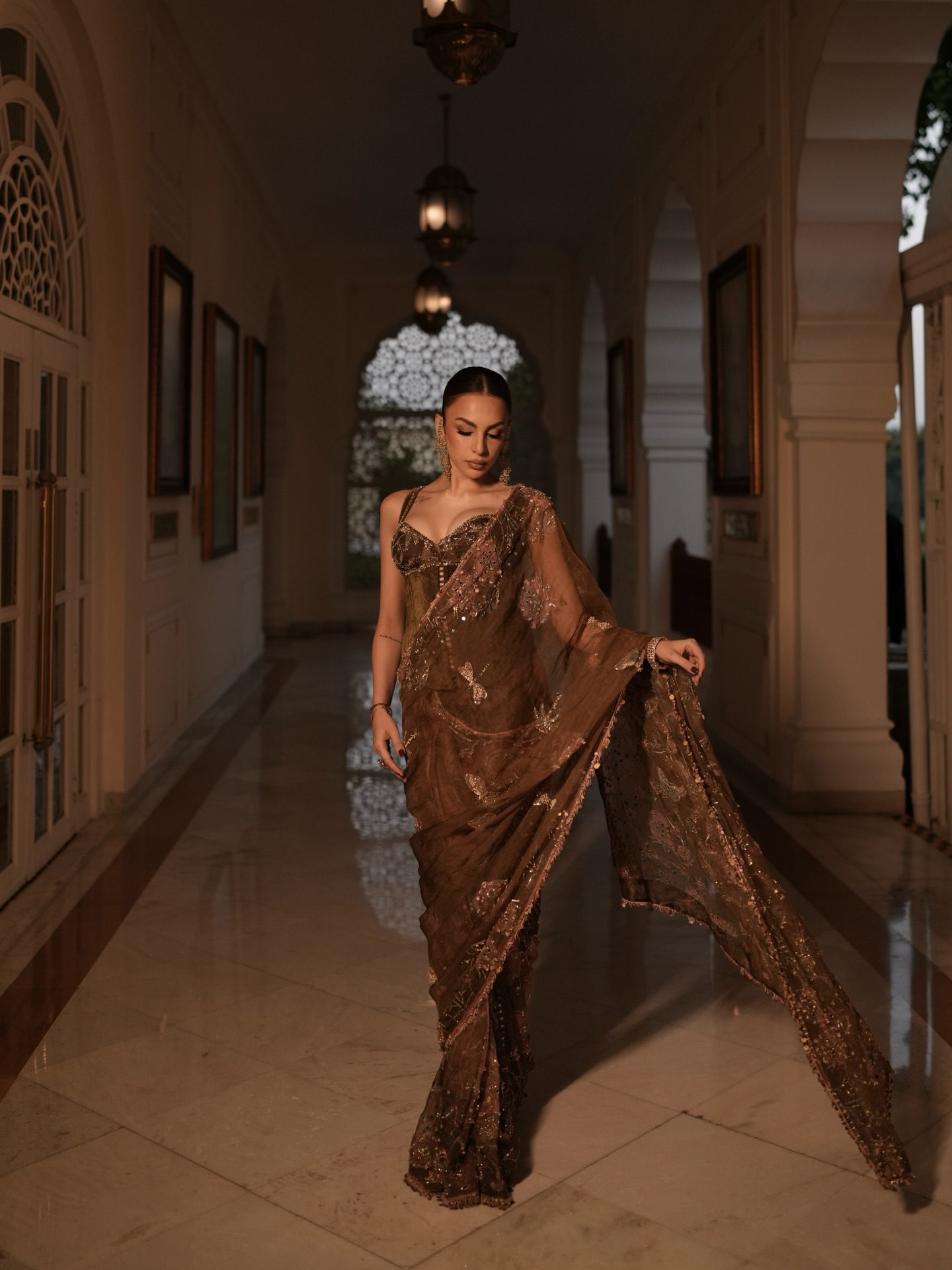 Nitibha Kaul keeps the accessories refined with statement earrings and a sleek bracelet, allowing the intricate craftsmanship of the ensemble to remain in focus.