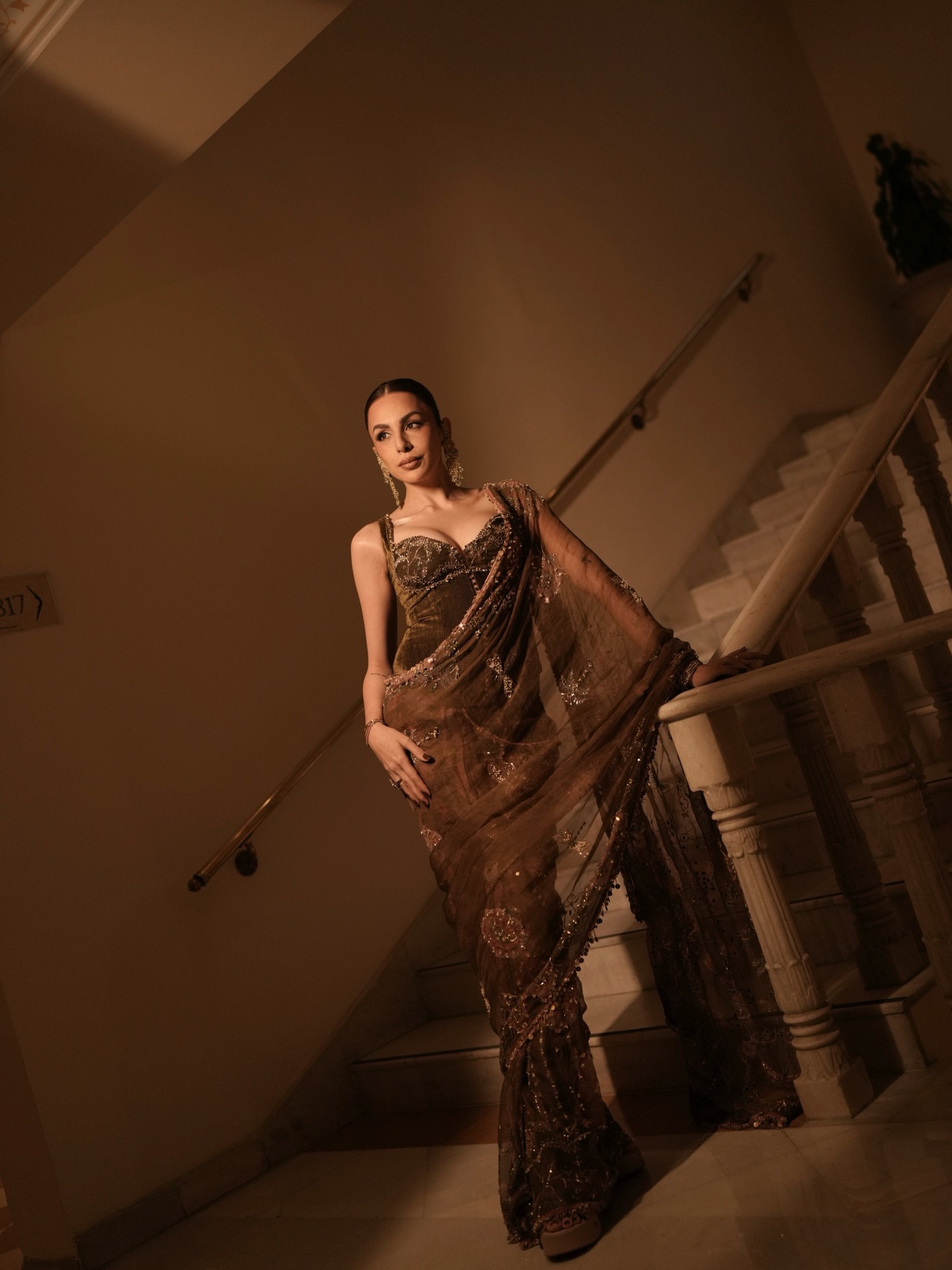 Nitibha Kaul completes the look with sculpted makeup, softly defined eyes, and a sleek pulled-back hairstyle that enhances the elegance of the outfit.