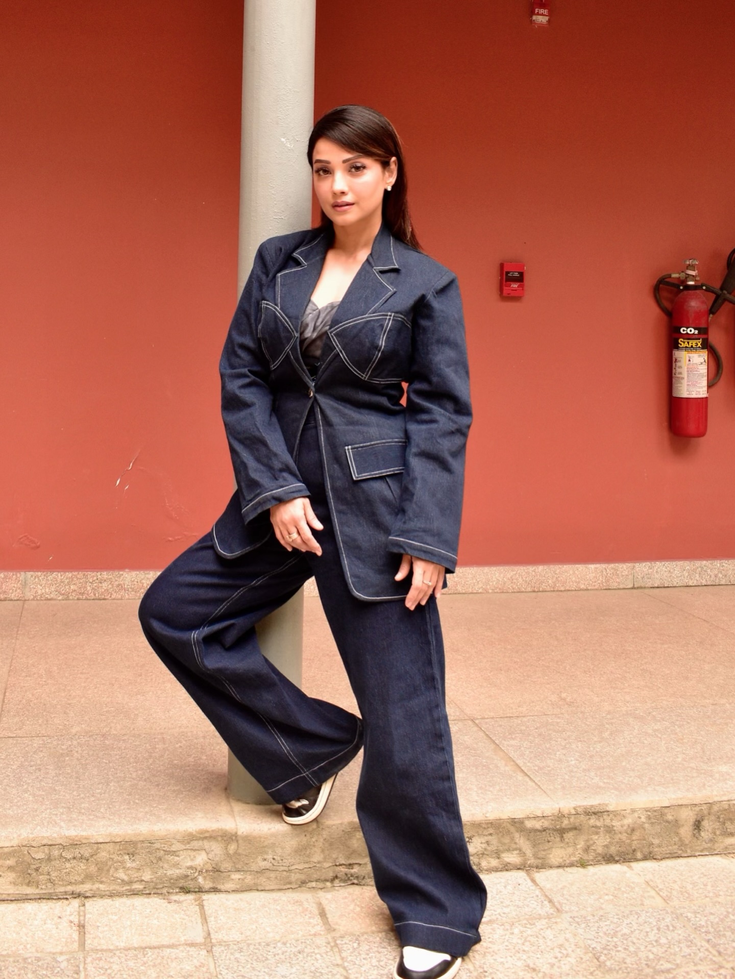 Adaa Khan elevates her look with a statement blazer featuring contrast stitching and contemporary cut-out details.