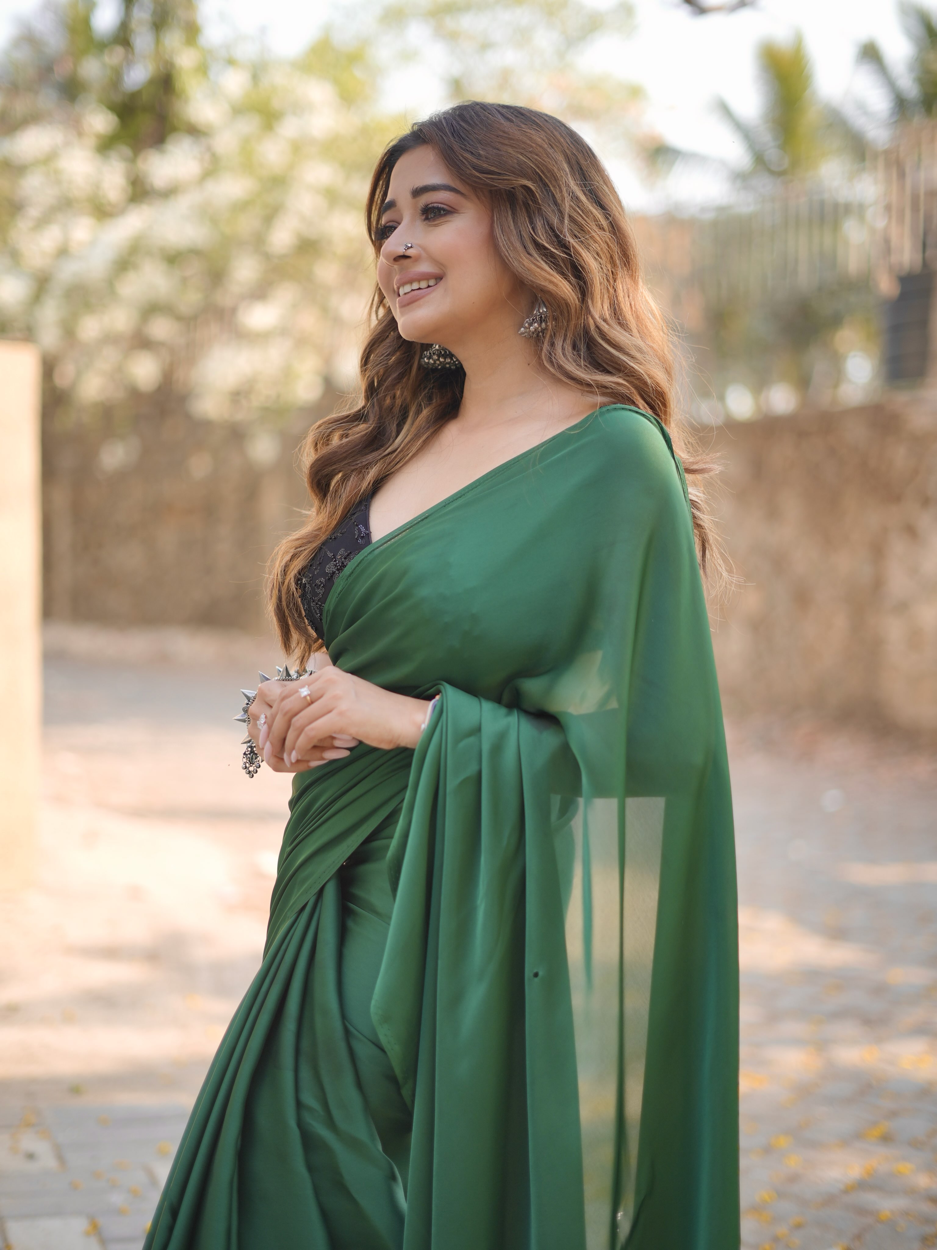 Tina Datta embraces the richness of jewel tones in a flowing green saree that exudes sophistication from every angle.