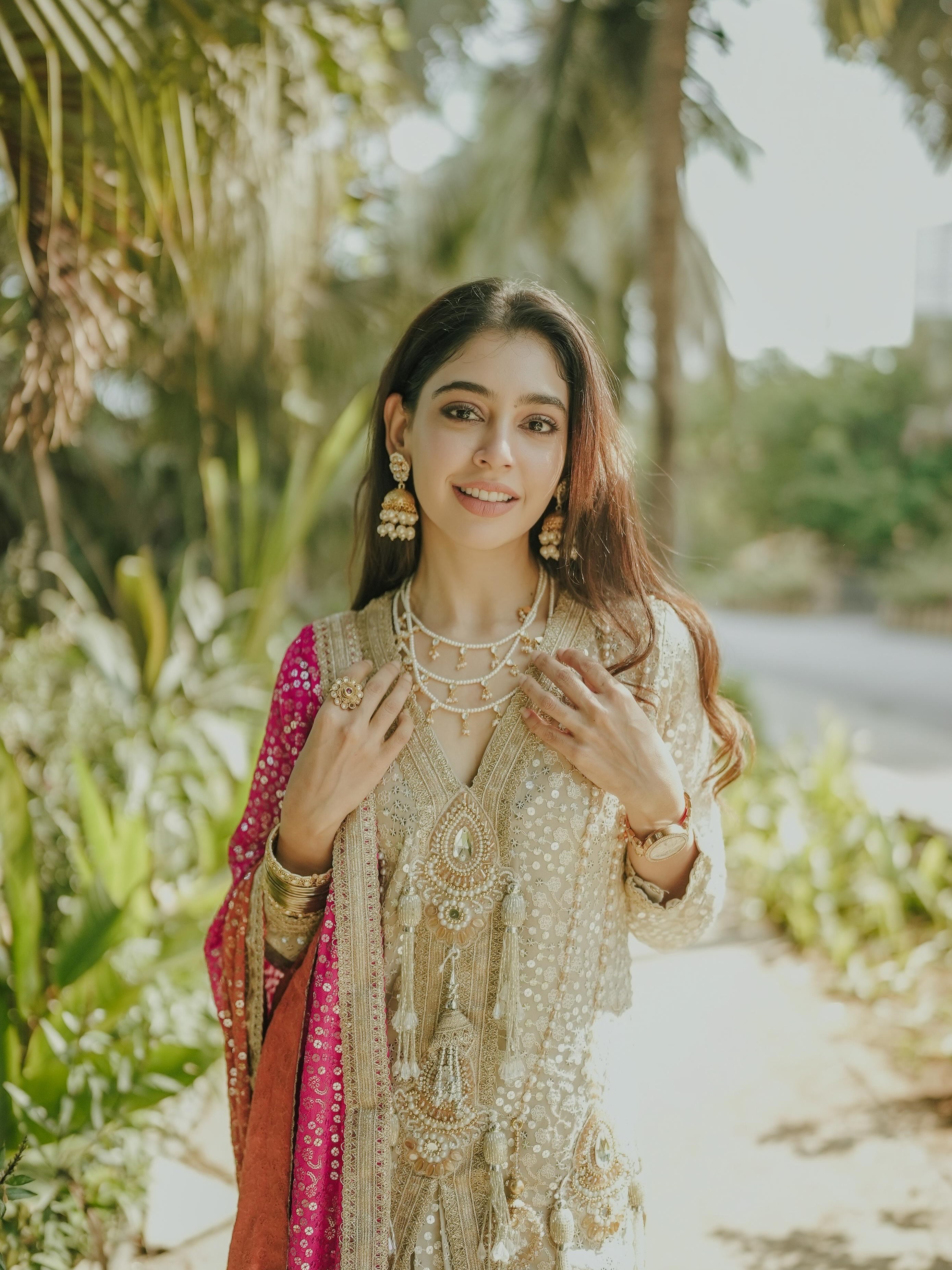 Niti Taylor completes the look with soft waves, statement earrings, and elegant styling that perfectly balances simplicity and grace.