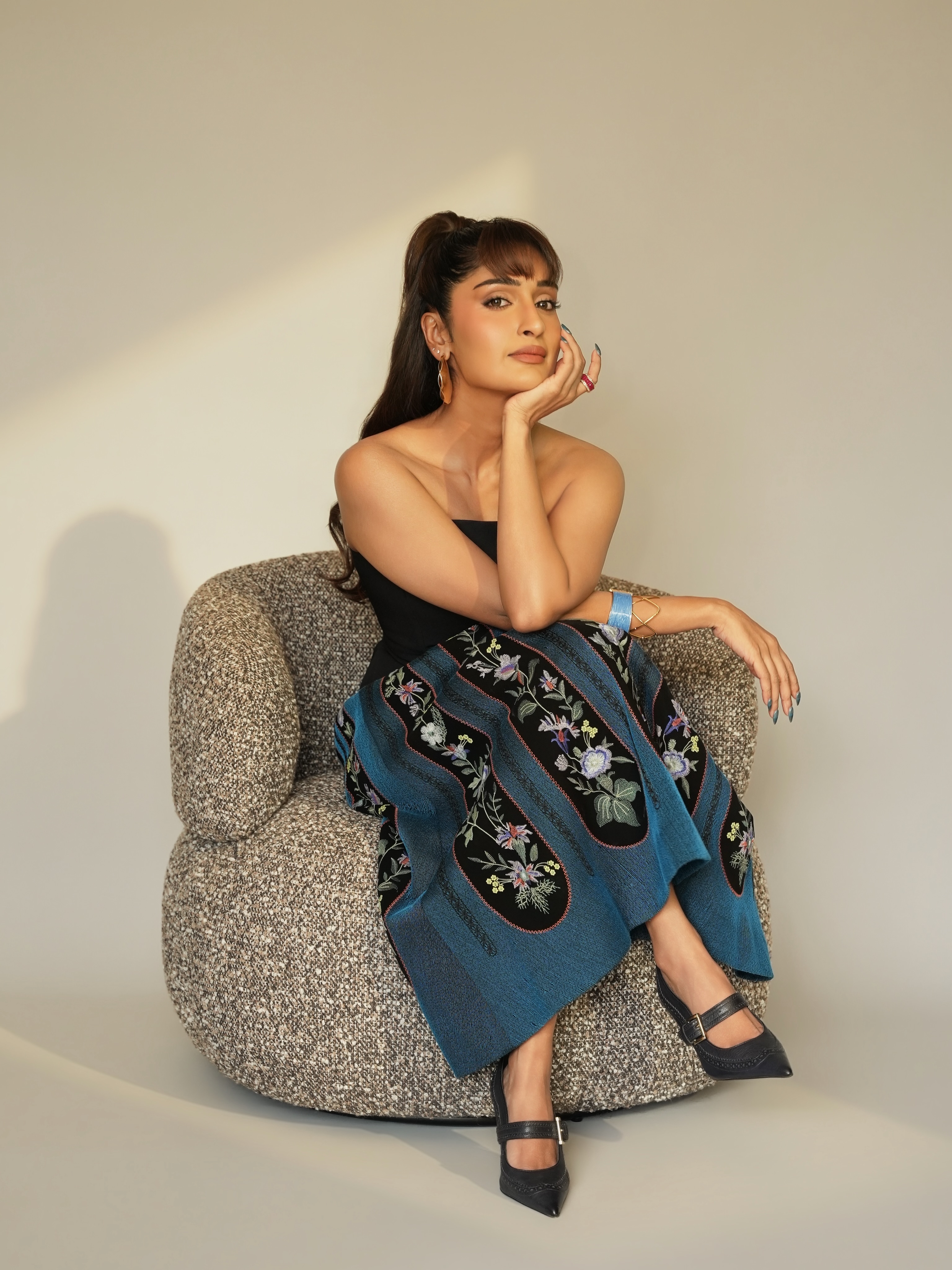 Niharika NM brings artistic charm to the look with a beautifully embroidered skirt featuring intricate floral motifs.