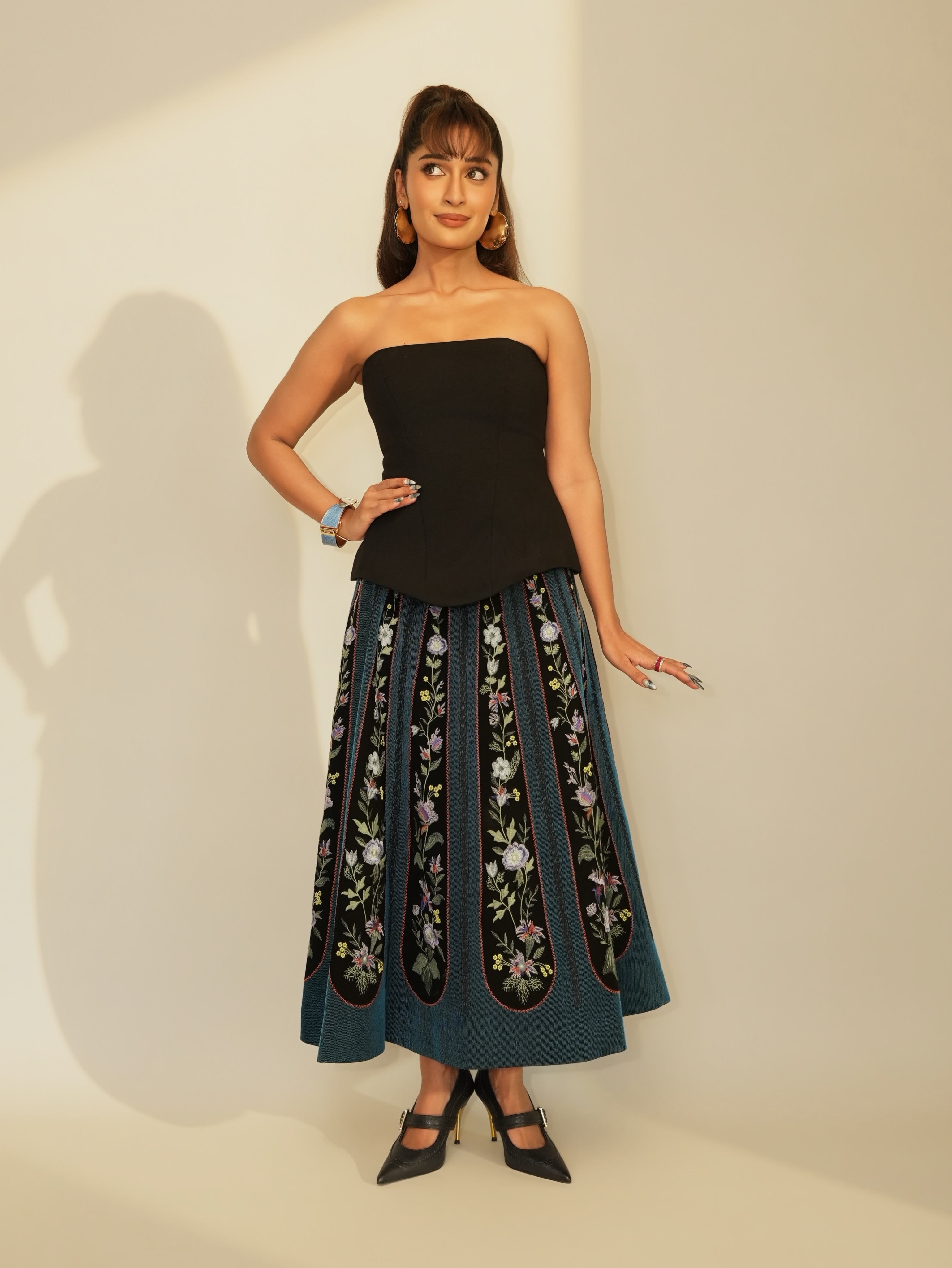 Niharika NM balances the outfit perfectly, pairing a sleek black bodice with vibrant statement detailing.