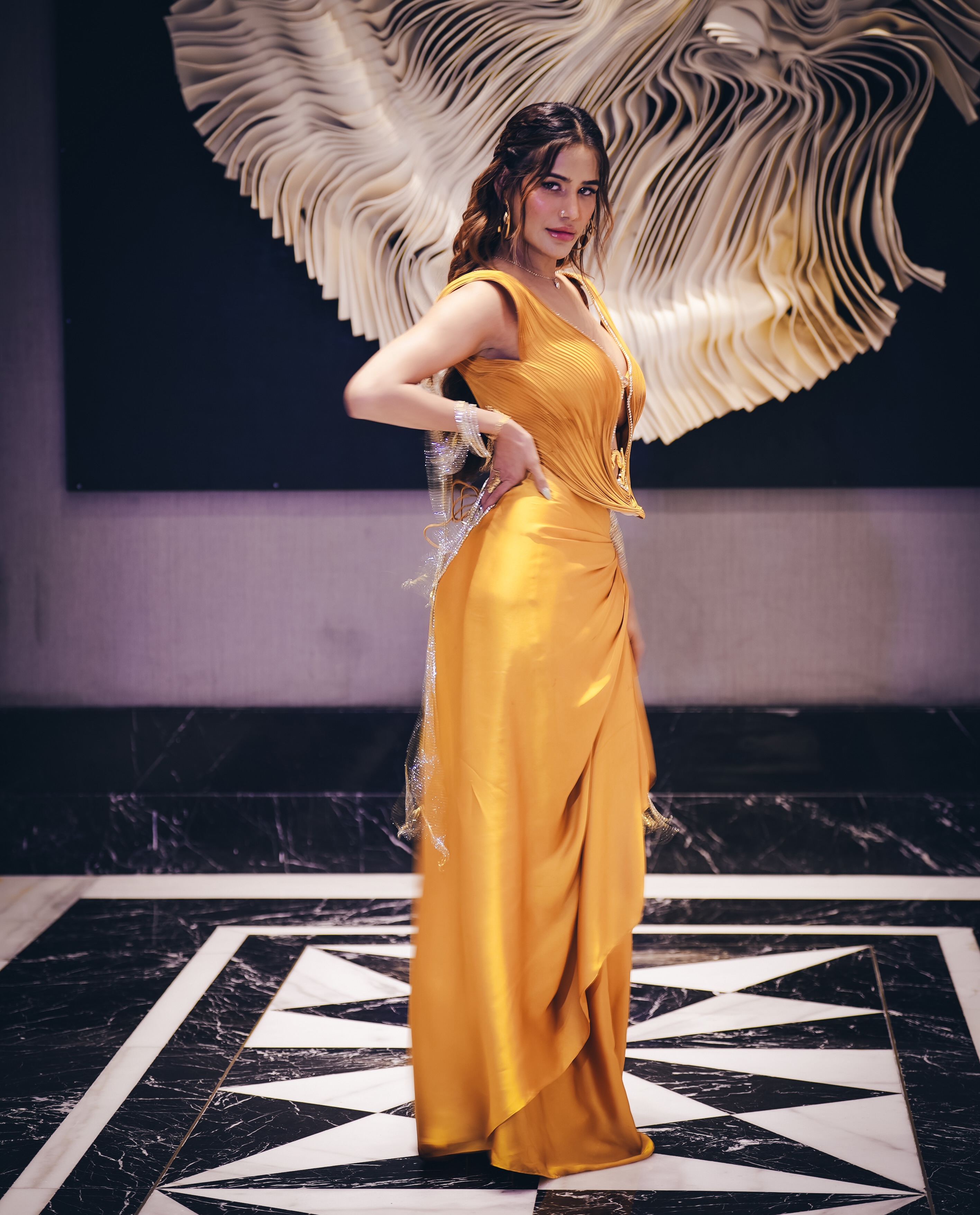 Poonam Pandey completes the fashion moment with effortless poise, proving that bold drapes and golden hues make an unforgettable combination.