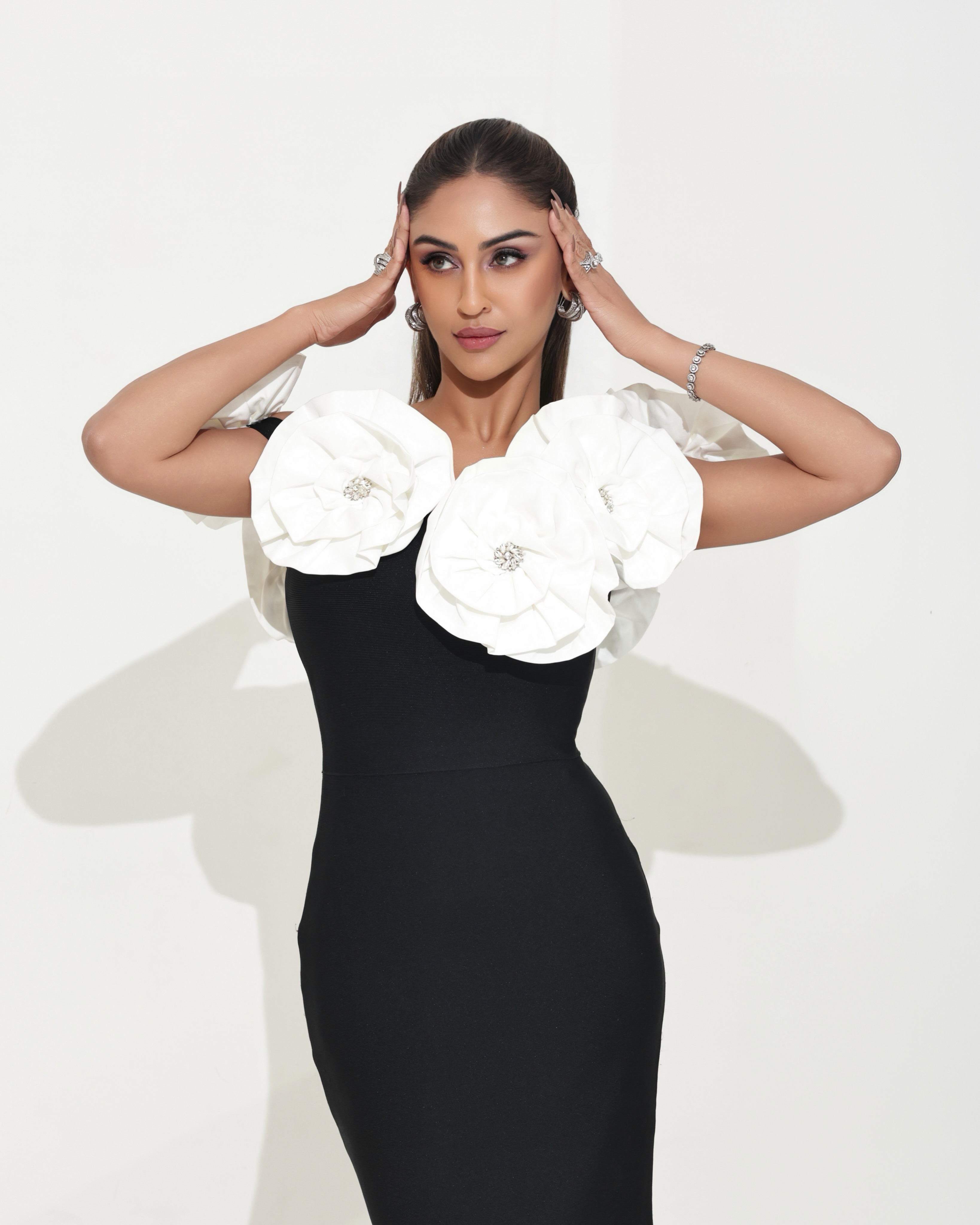 Krystle D'Souza complements the ensemble with delicate diamond earrings, stacked rings, and a statement bracelet that add just the right amount of glamour.