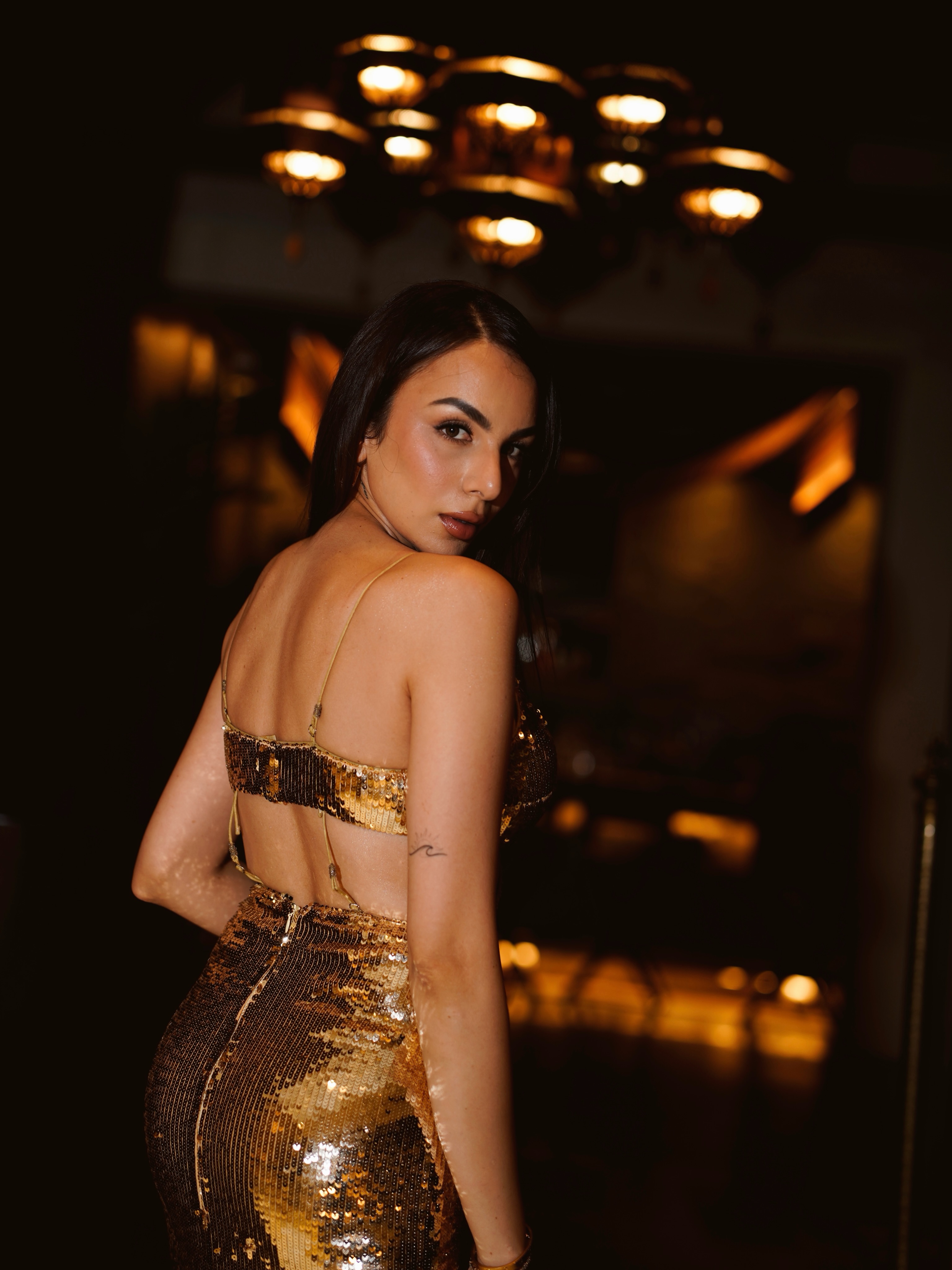 Nitibha Kaul turns heads in a body-hugging gold gown adorned with shimmering sequins that catch the light beautifully from every angle.