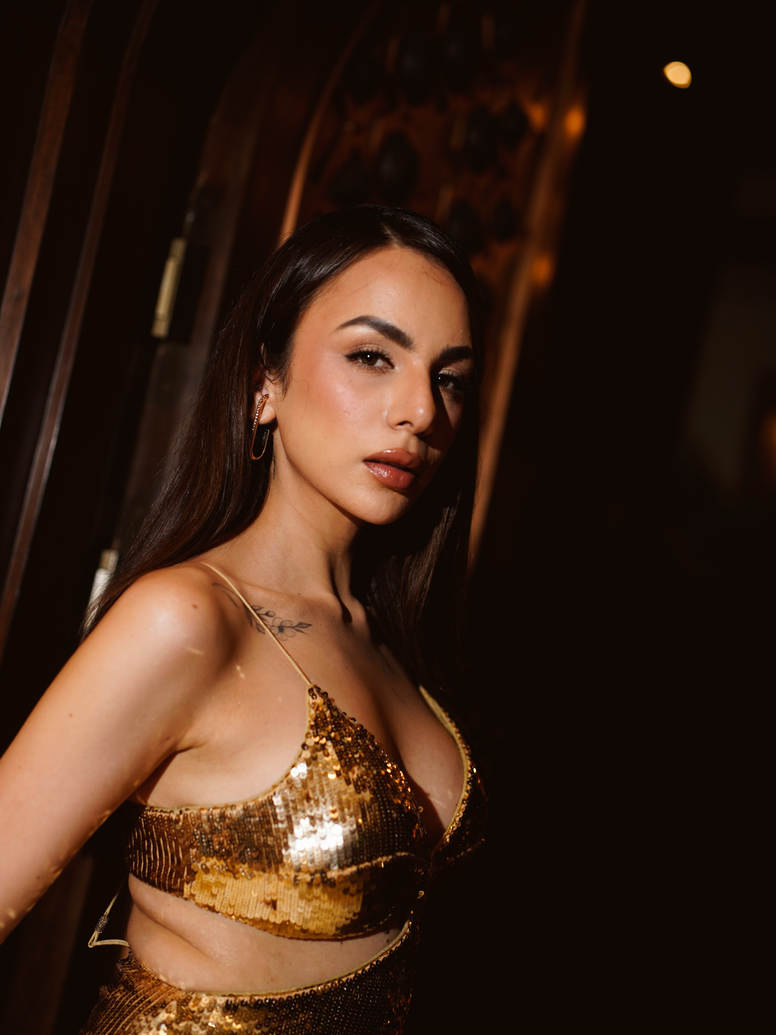 Nitibha Kaul opts for bronzed makeup, defined eyes, and a nude lip, while her sleek open hair complements the glamorous evening look.