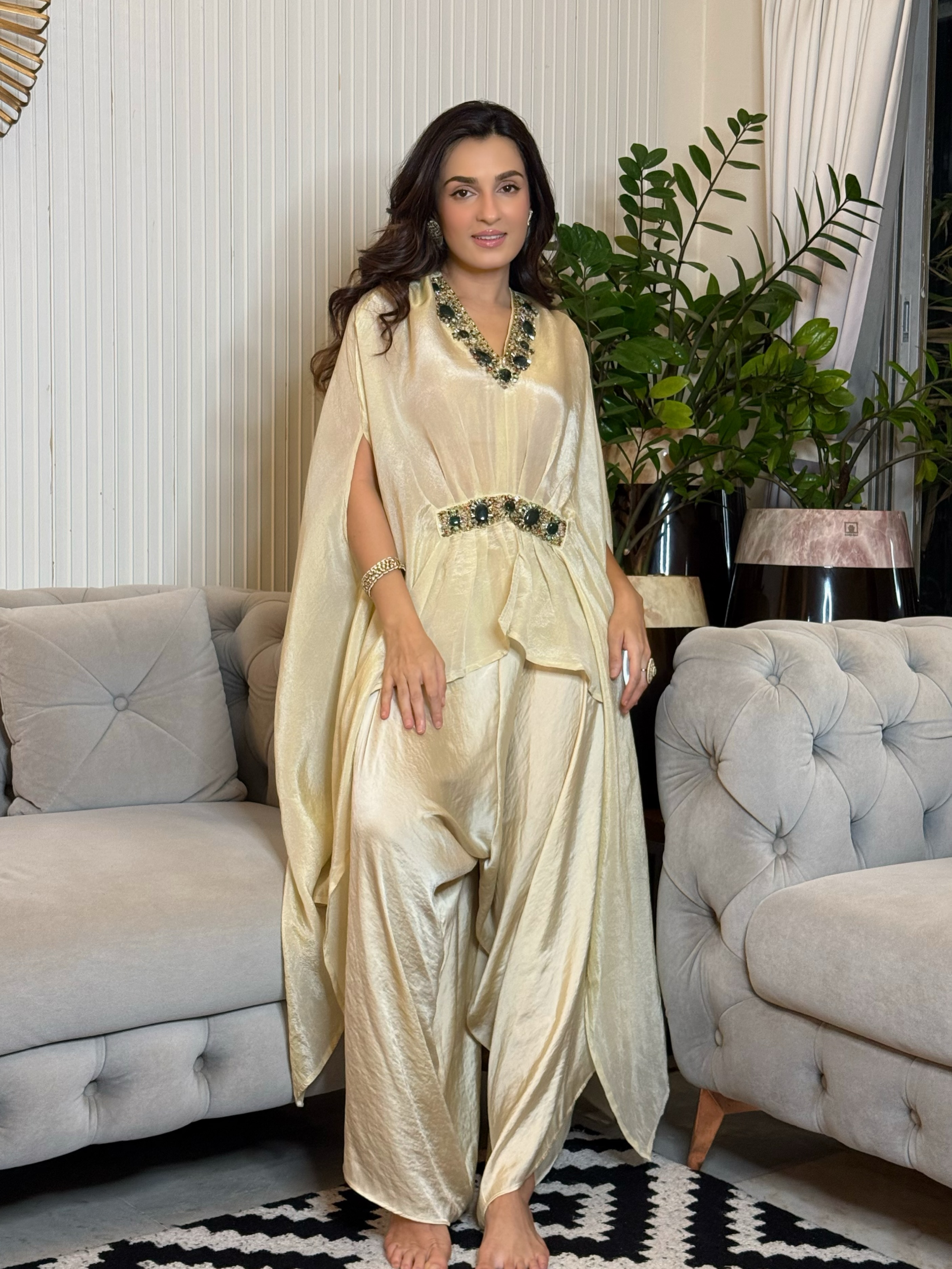 Shiny Doshi elevates the outfit with an emerald-toned necklace, a matching belt, and bold rings that add a touch of opulence.