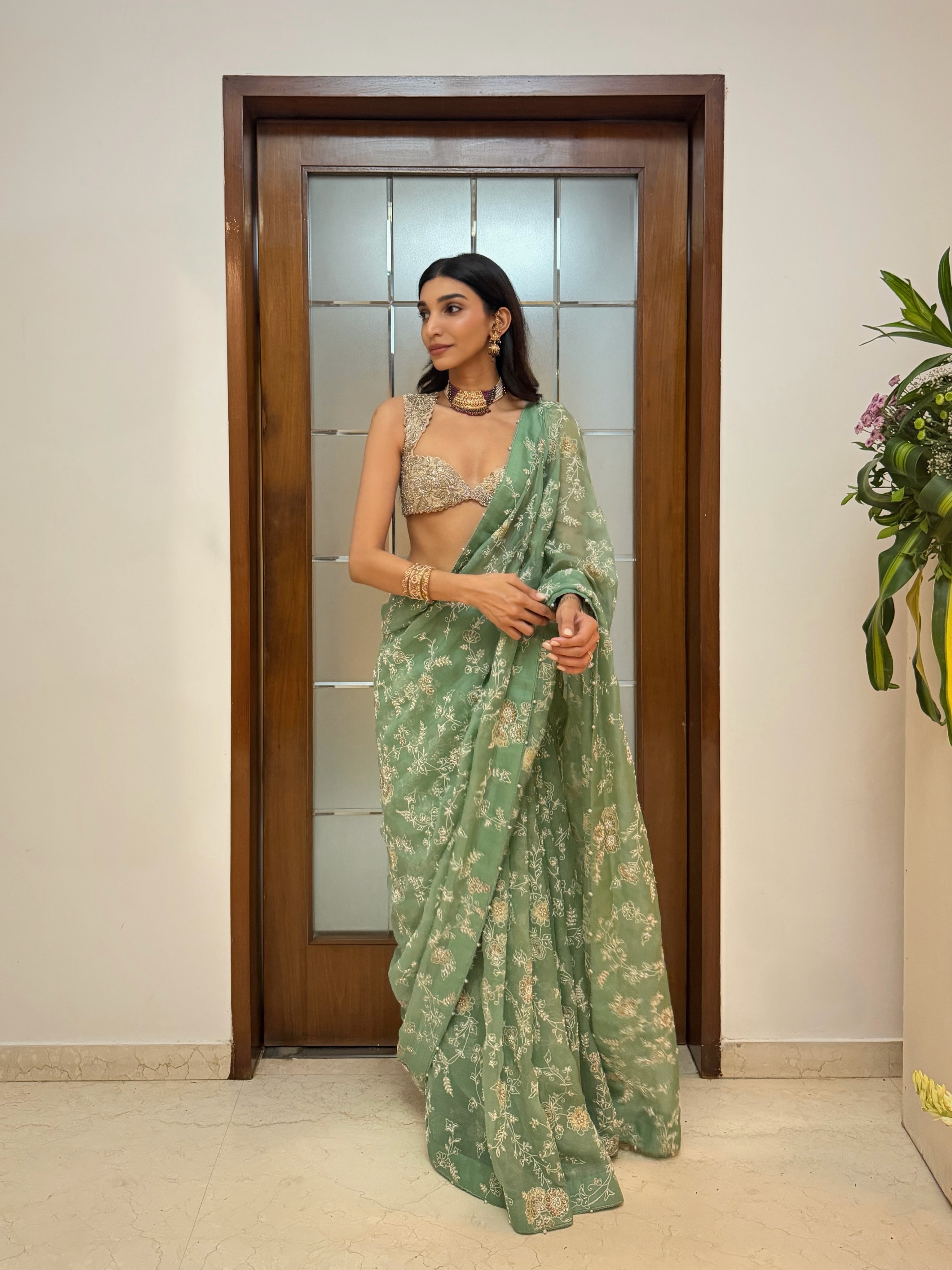 Juhi Godambe steals the spotlight in a delicate floral saree featuring intricate embroidery and soft pastel hues that are perfect for wedding festivities.