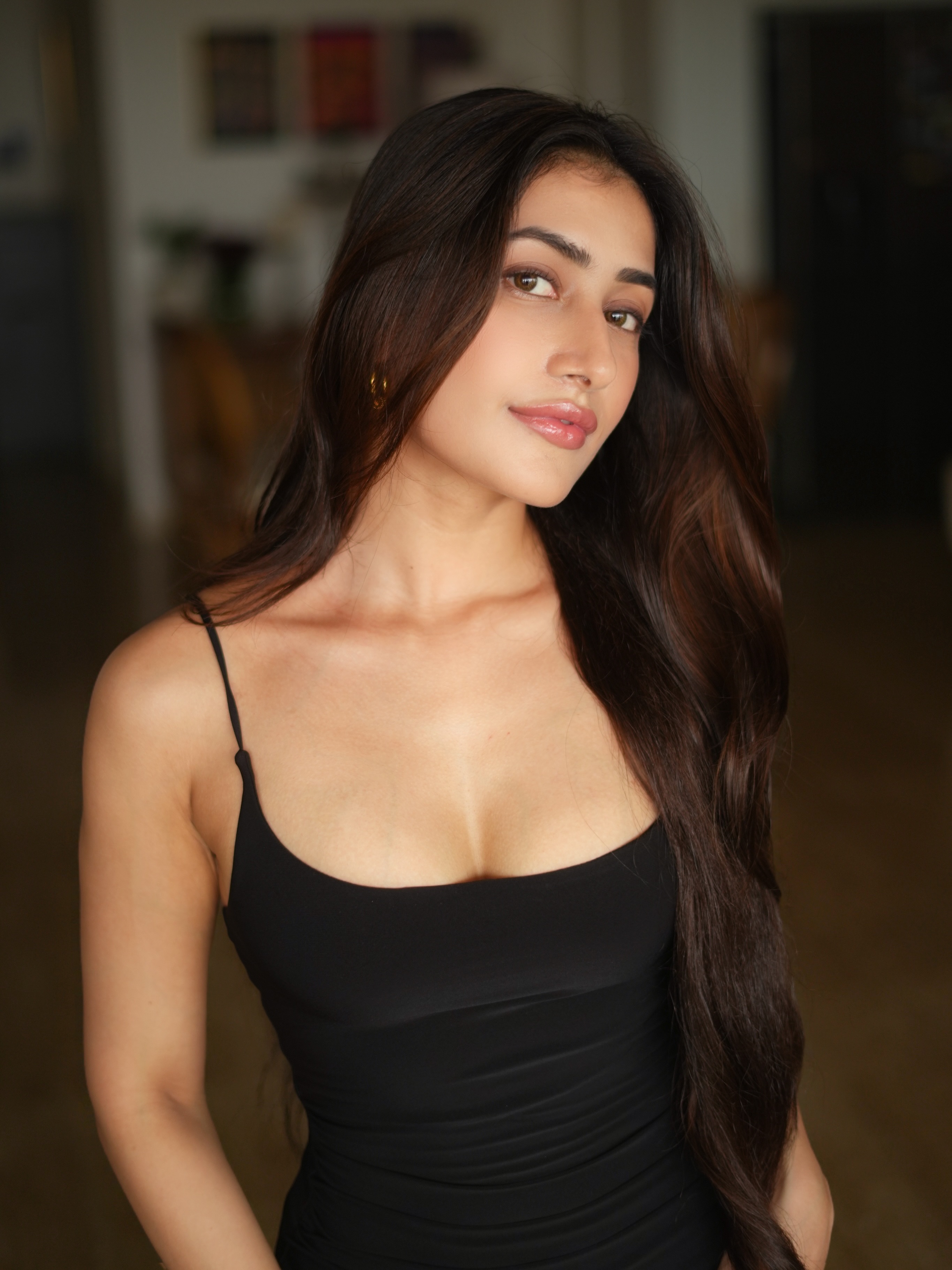 Dhanashree Verma stuns in a body-hugging black gown featuring a chic neckline and a daring thigh-high slit that adds a bold edge.
