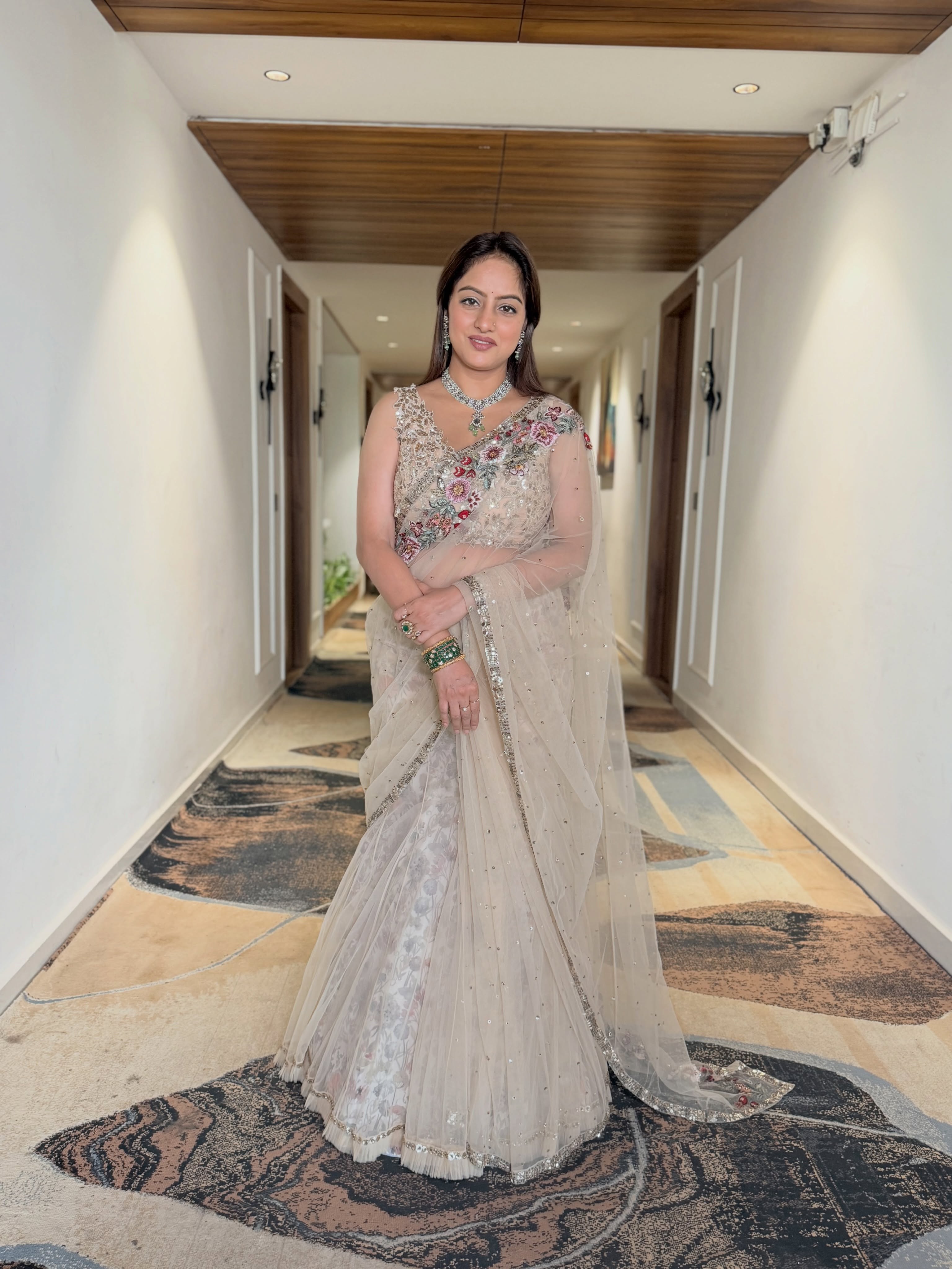 Deepika Singh elevates the ensemble with a statement necklace, matching earrings, stacked bangles, and elegant rings that complement the saree beautifully.