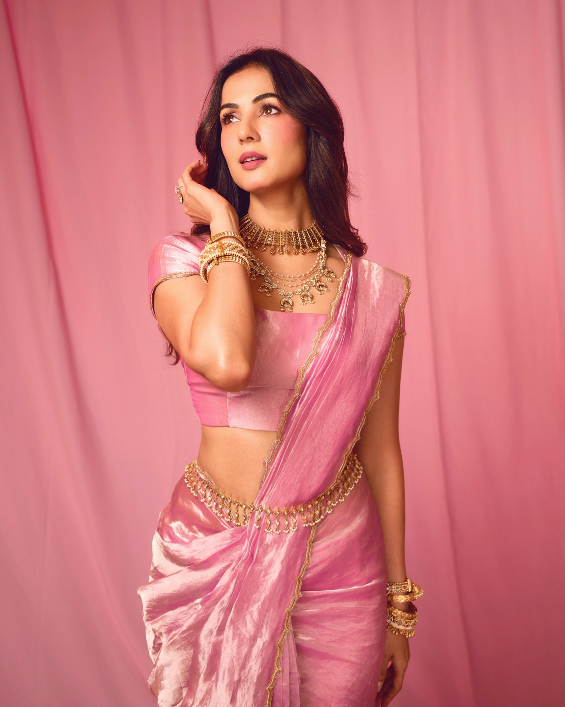 Sonal S Chauhan looks breathtaking in a satin-finish pink saree paired with a matching blouse, creating a sleek and effortlessly refined silhouette.