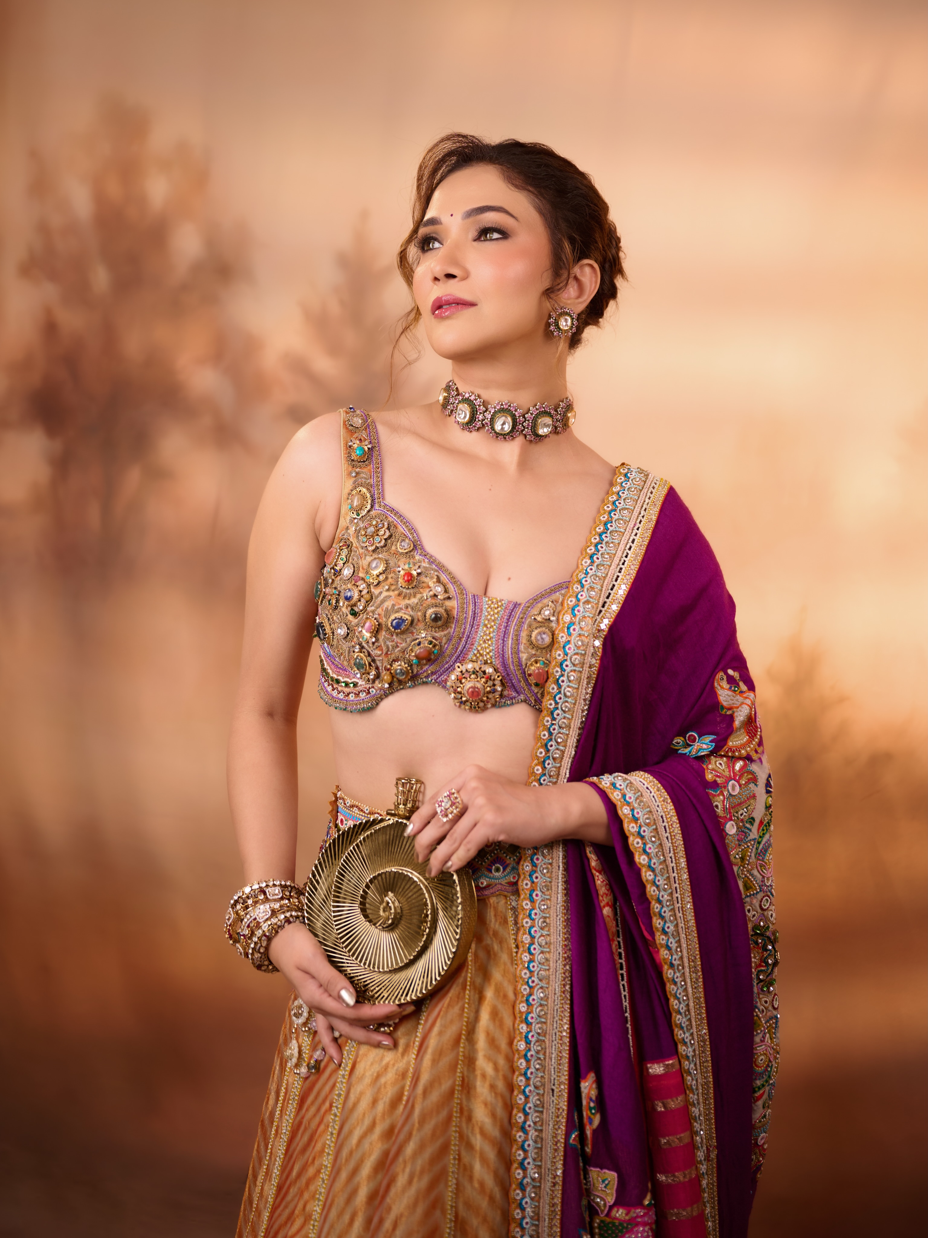 Ridhima Pandit pairs a heavily embellished blouse with a gold-toned lehenga, creating a striking mix of colour and intricate detailing.