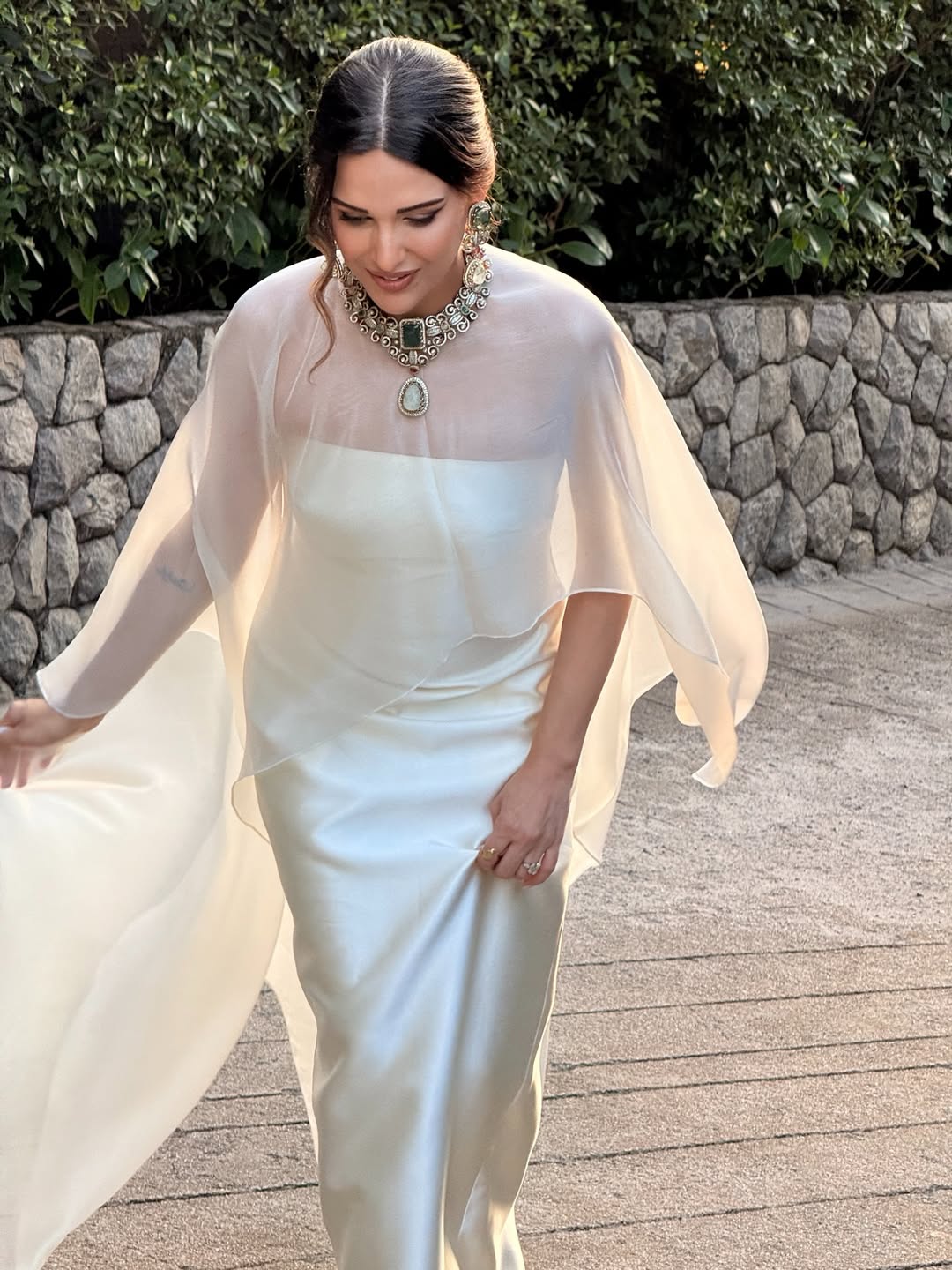Himanshi Khurana serves soft minimalism in a structured strapless silhouette topped with a weightless draped overlay perfect for oceanside style.