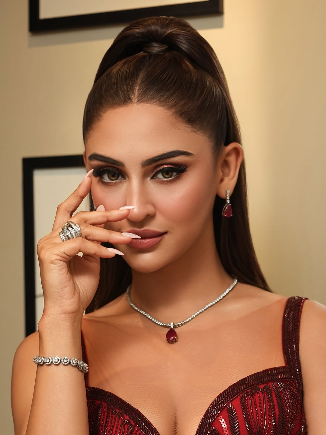 Krystle DSouza slays in a fitted crimson gown with bold lines and a sleek, sculpted silhouette.