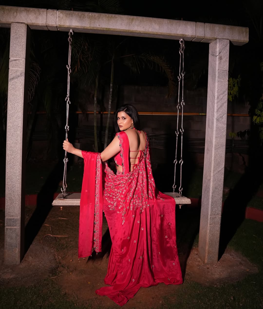 Mannara Chopra stuns in a rich red saree with a flowy drape and bold movement.