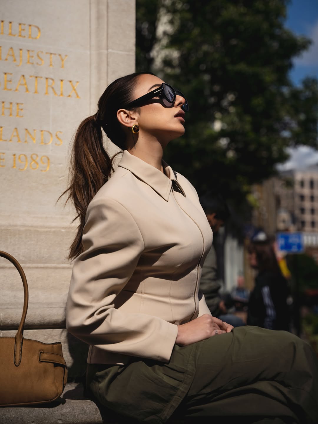 Nitibha Kaul adds a luxe touch with a classic tan handbag and sleek sunglasses, enhancing the off-duty chic vibe.