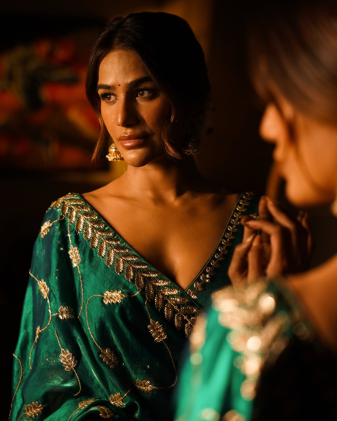 Poonam Pandey elevates the look with a structured blouse and fluid drape, highlighting a clean and traditional silhouette.