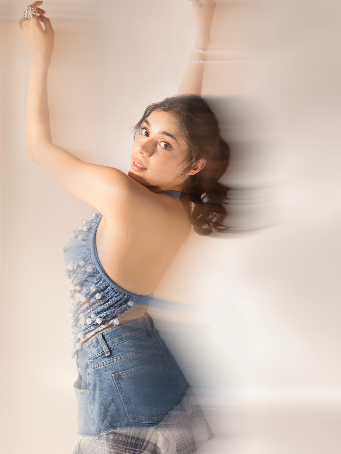 Eisha Singh's halter-style top is adorned with scattered pearls, adding a touch of elegance to the contemporary silhouette.