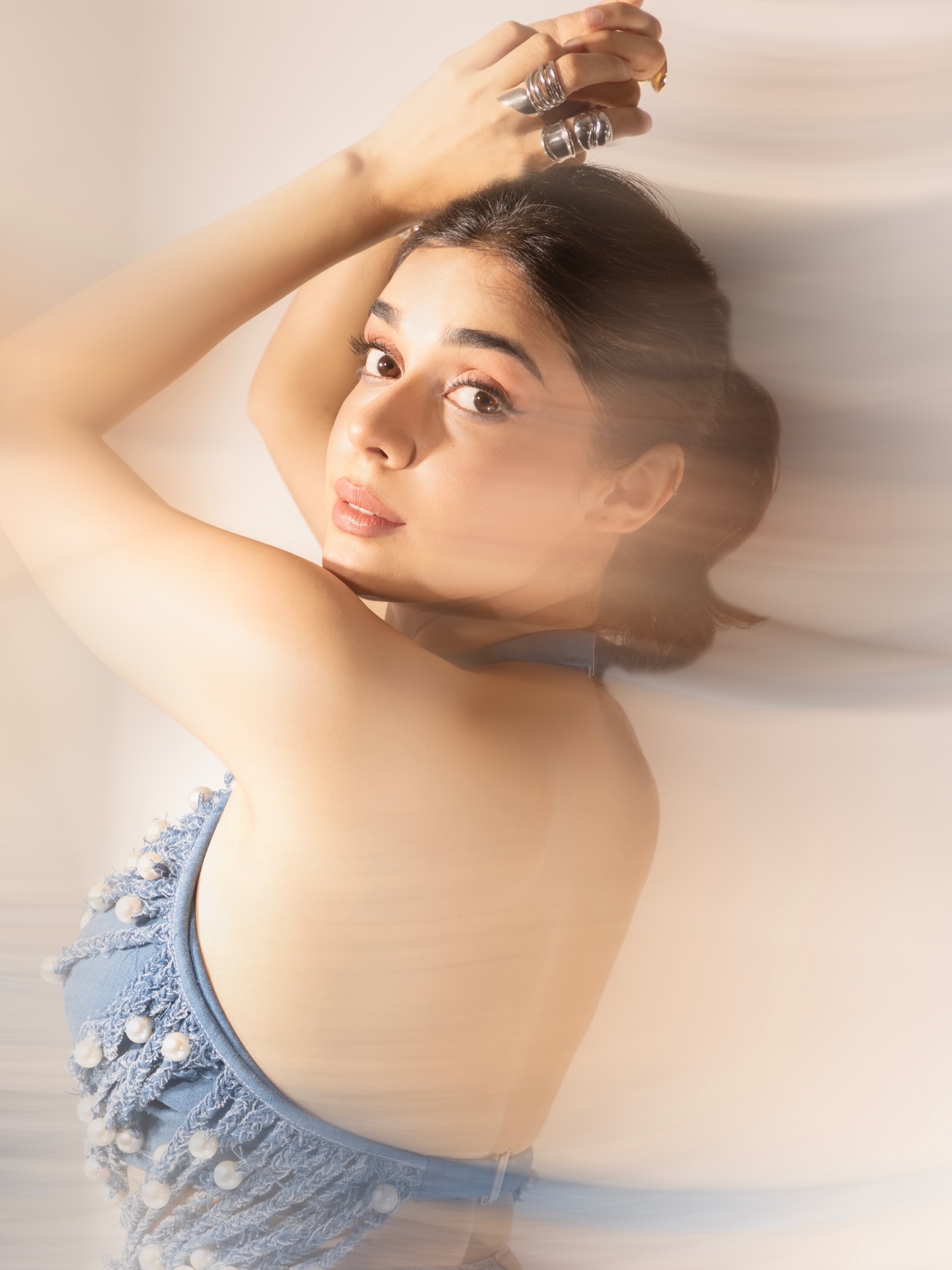 Eisha Singh's outfit combines rugged denim with soft plaid accents, bringing depth and personality to the ensemble.