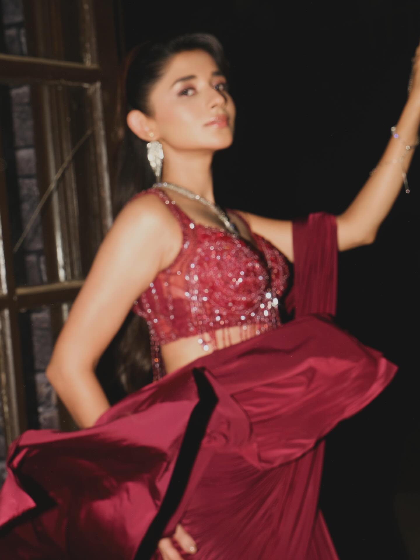 Kanika Mann elevates the look with a shimmering embellished blouse that brings just the right amount of drama.