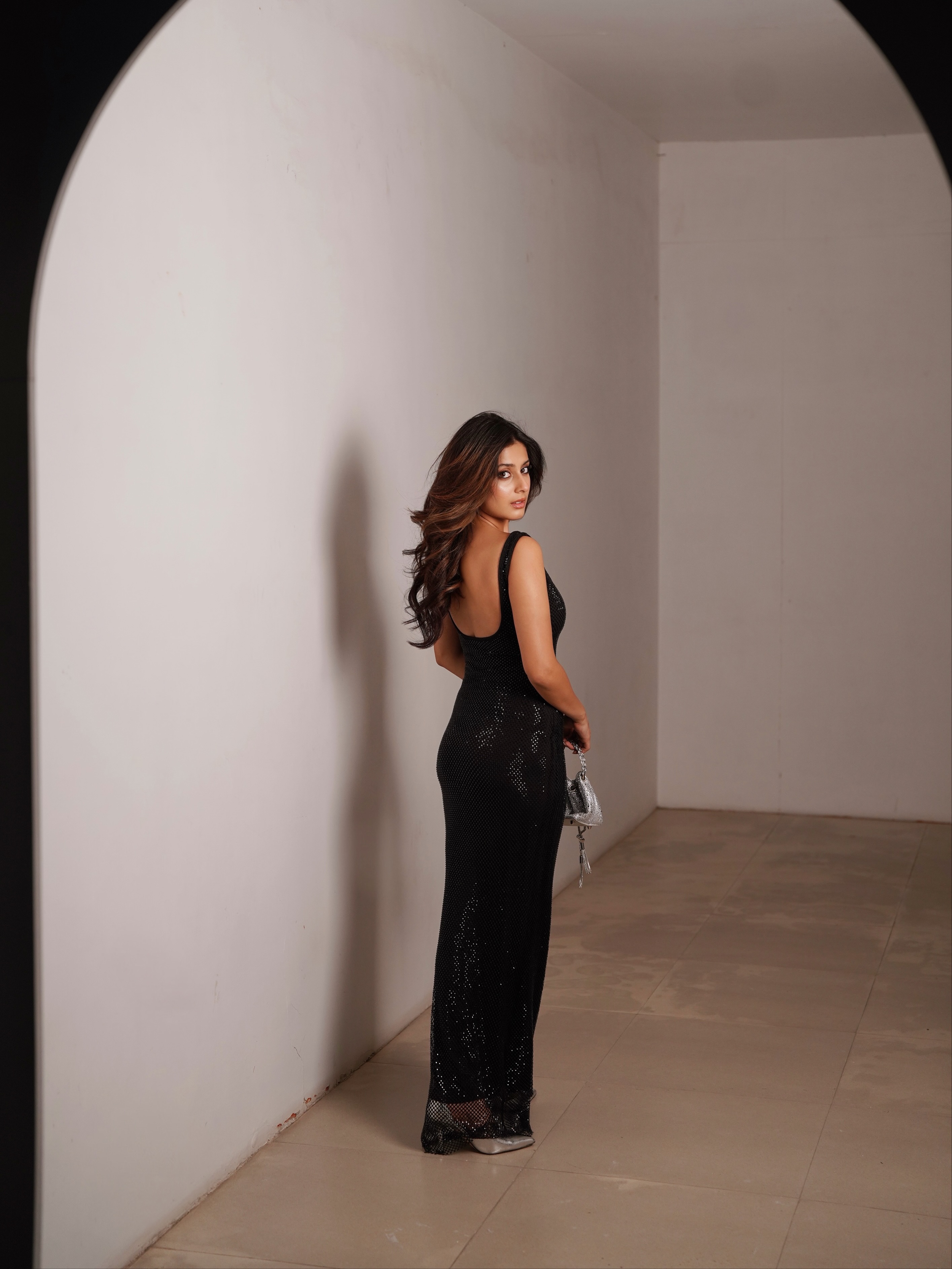 Isha Malviya completes the look with radiant makeup, softly defined eyes, and voluminous loose waves that perfectly complement the outfit.