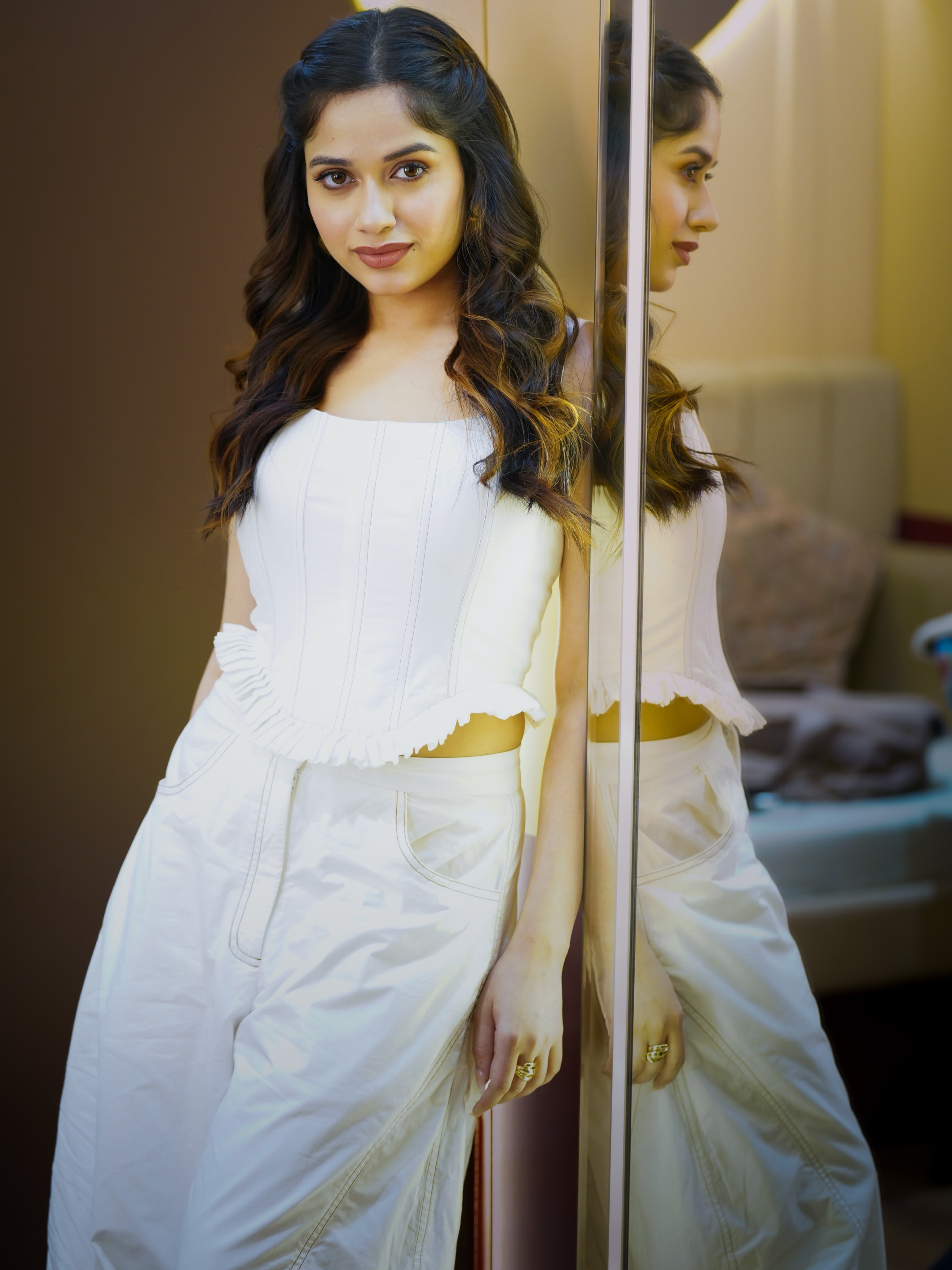 Jannat Zubair completes the look with radiant makeup, softly defined eyes, and voluminous loose curls that add a hint of romance to the ensemble.