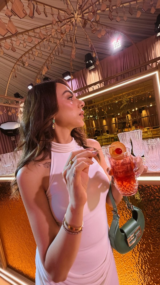 Nitibha Kaul complements the outfit with soft glam makeup, radiant skin, and voluminous waves that perfectly balance the dress's polished aesthetic.