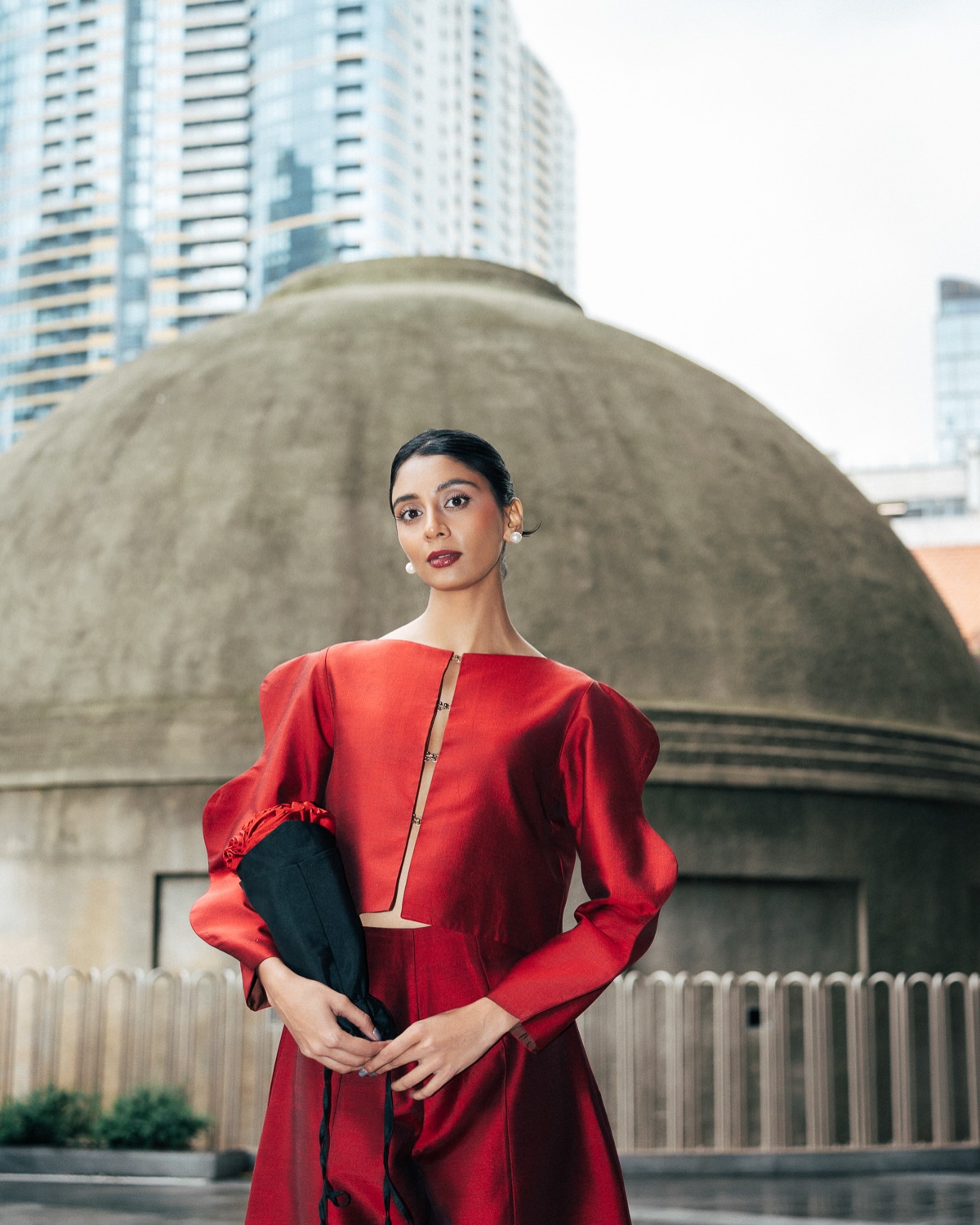 Dolly Singh keeps the beauty look refined with softly defined makeup and a sleek pulled-back hairstyle that allows the dramatic outfit to take centre stage.