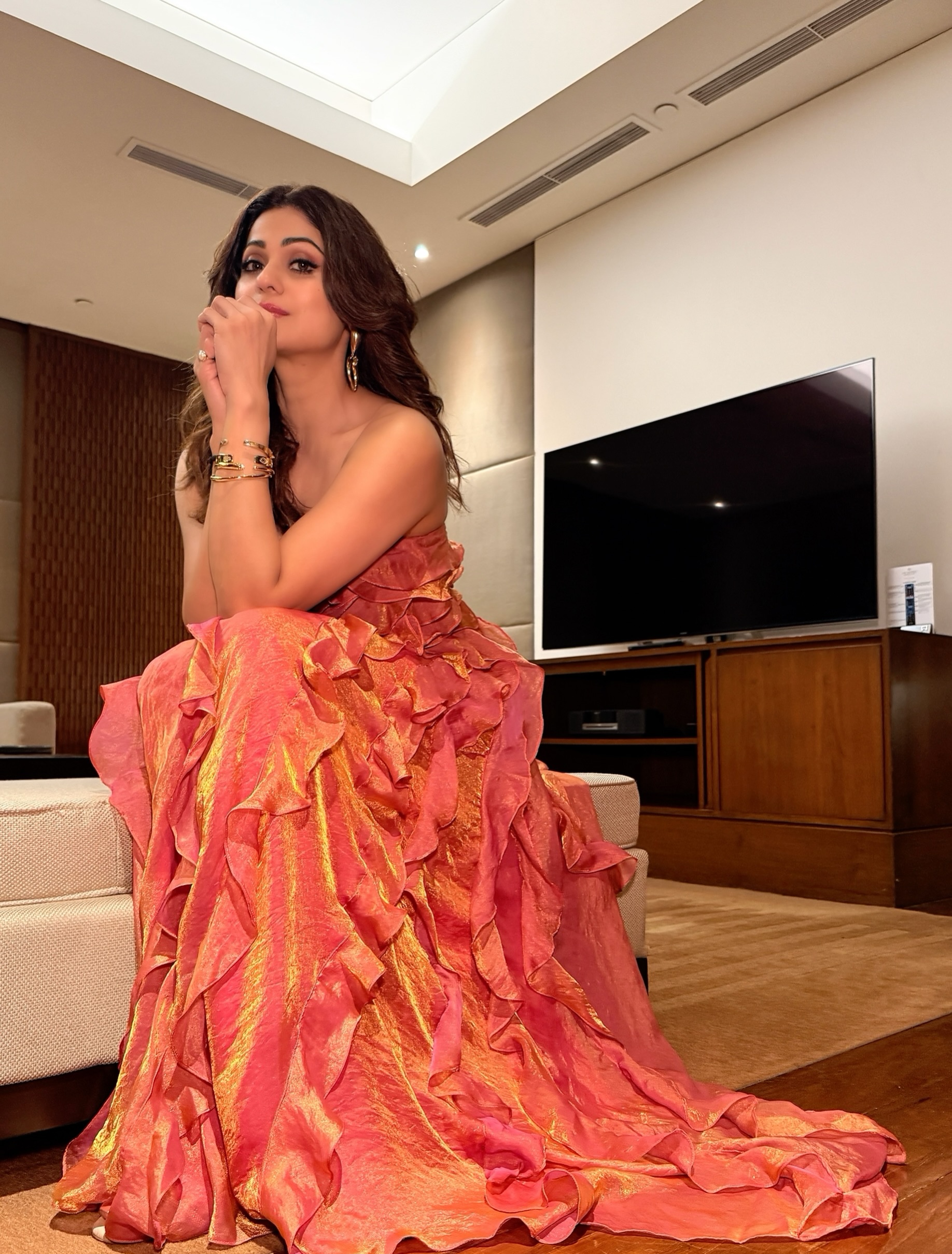 Shamita Shetty keeps her accessories chic and minimal with delicate gold-toned bracelets and strappy heels, letting the gown remain the star of the look.